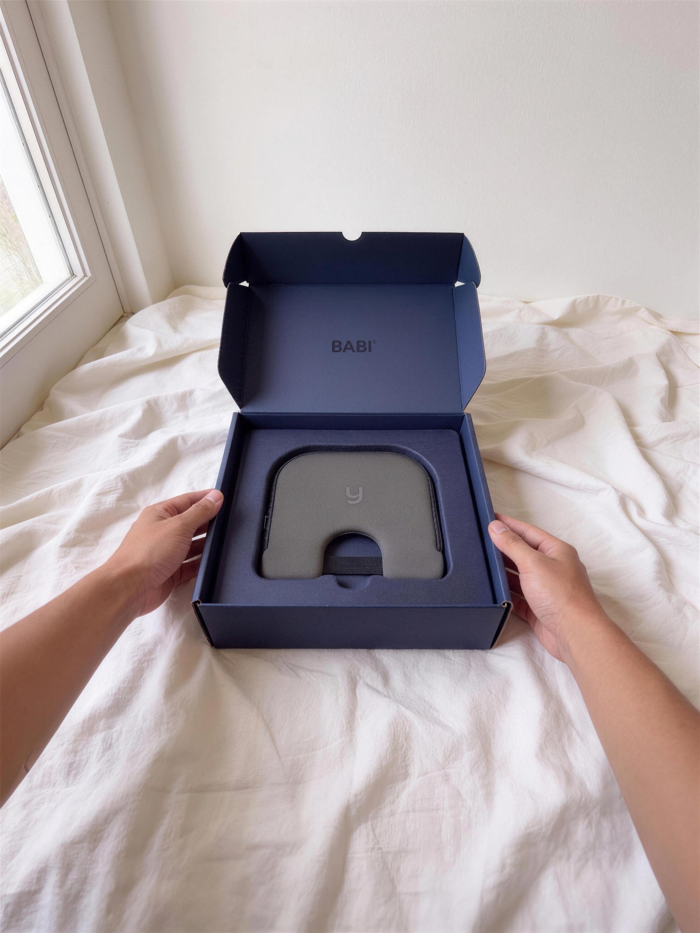 The Babi Seat cushion in its navy box