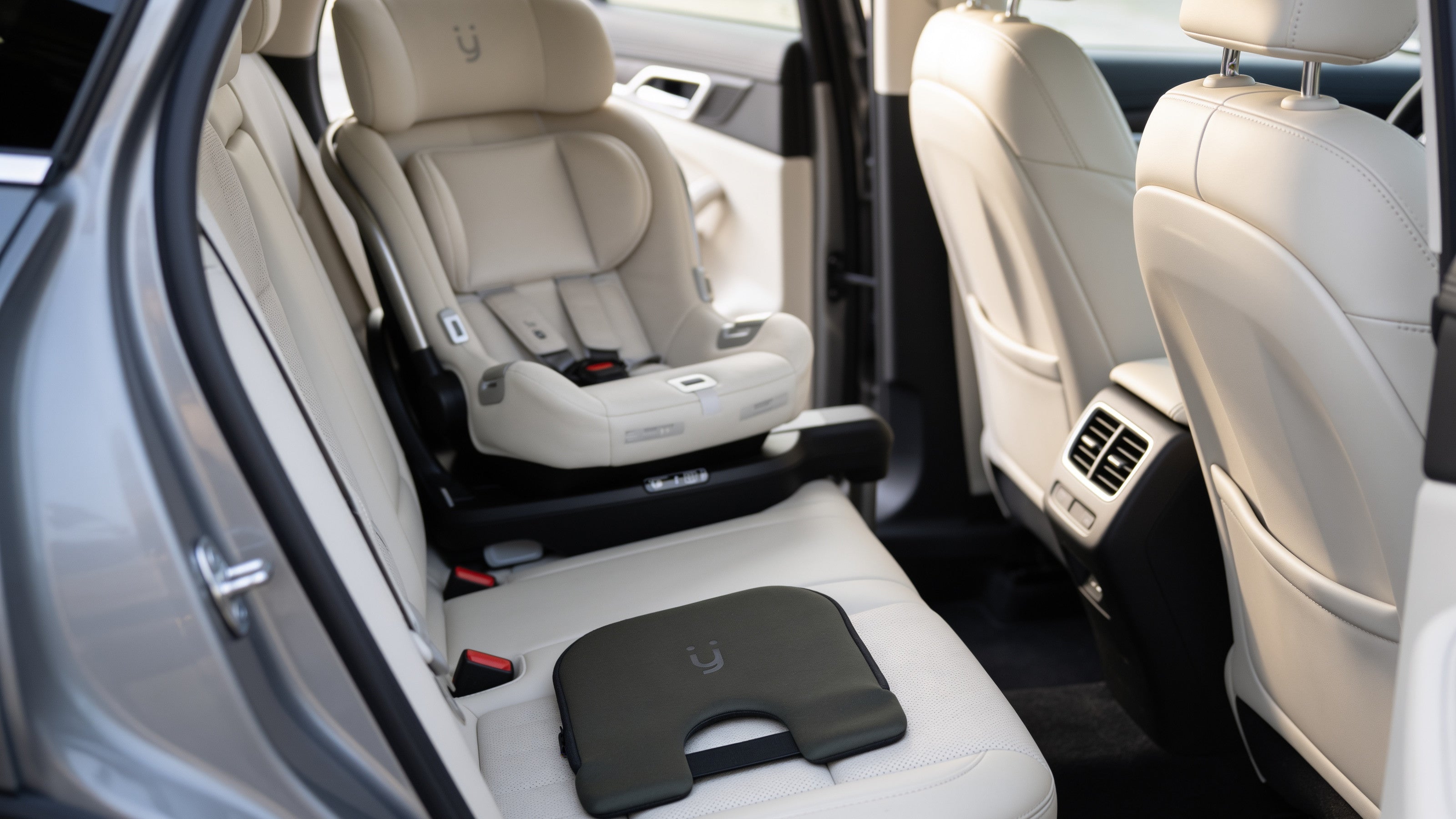 Babi Seat™ cushion on the back seat beside an infant car seat