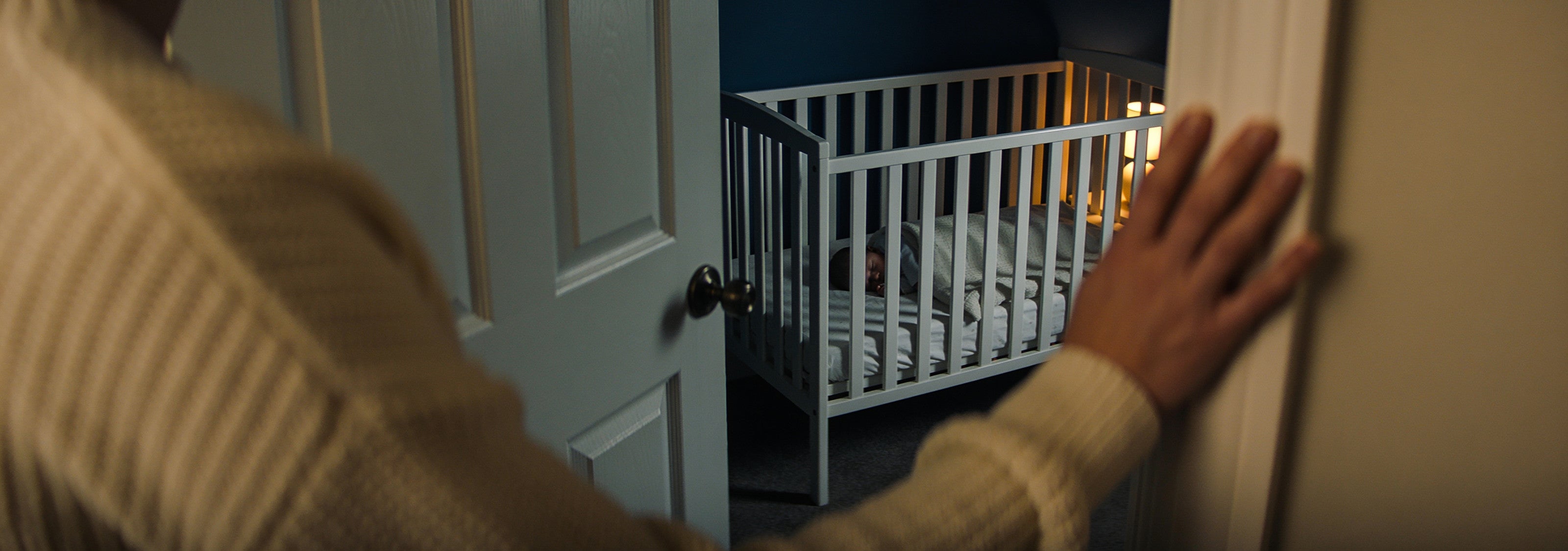 A dim nursery at night seen from the doorway